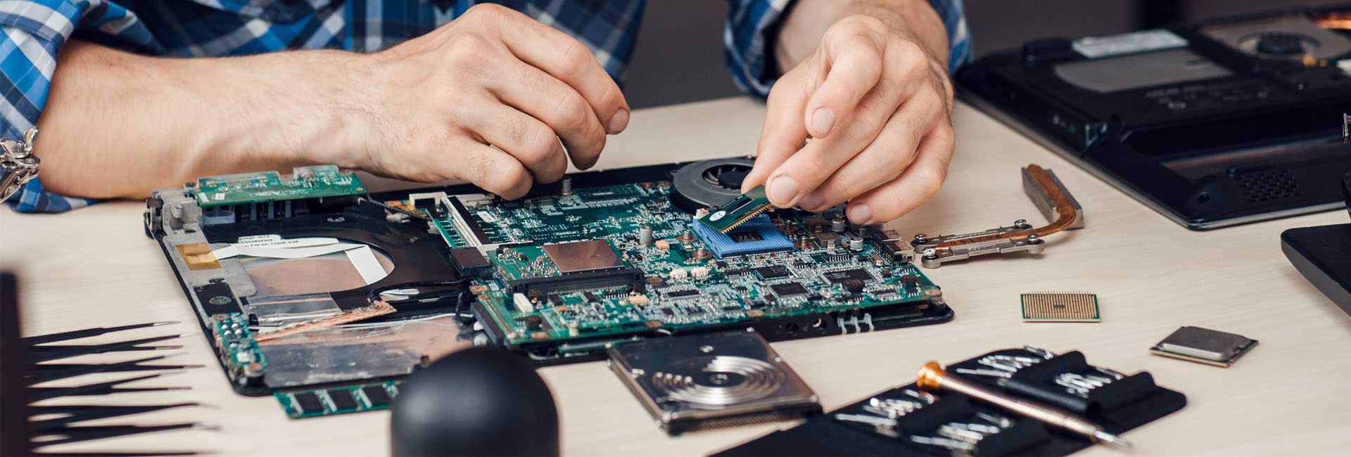 Repairman Disassembling Laptop Motherboard